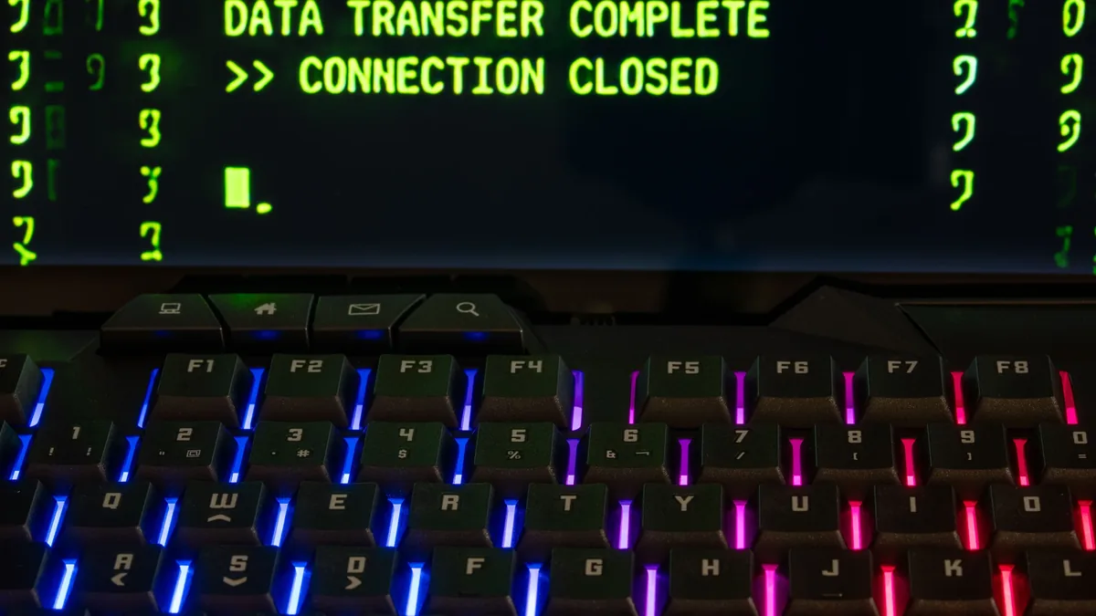 A computer screen displaying a data transfer message, with a keyboard in the foreground.