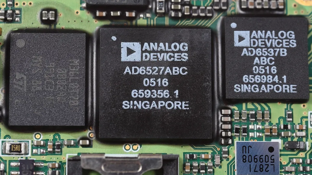 A close-up view of a circuit board with three integrated circuits (ICs) and various other electronic components.
